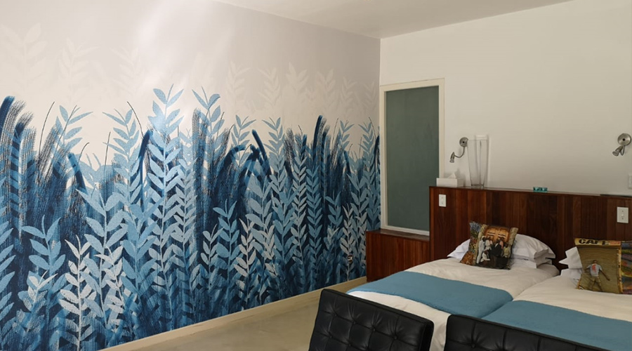 bedroom wallpaper with with graphic of plants in differing blue hues