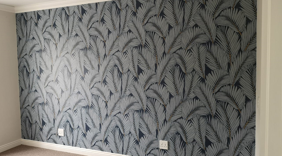bedroom wallpaper with natural theme and big fronds in a repeat pattern design