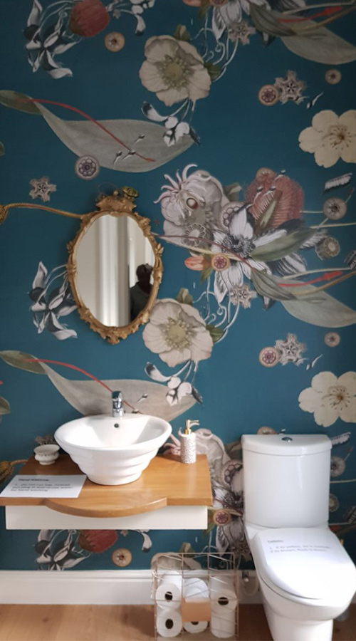 guest bathroom wallpaper featuring birds and floral patterns