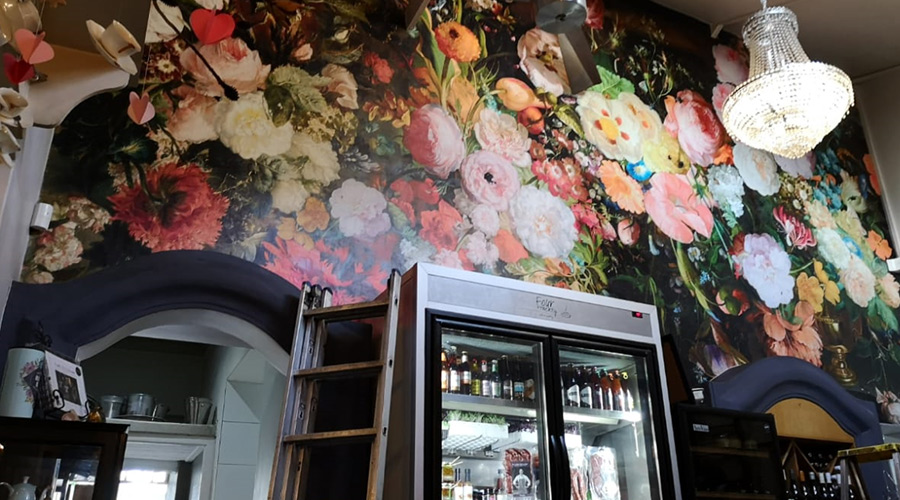 installation of floral wallpaper in morning eatery