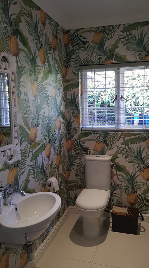 bathroom wallpaper with a tropical style and repeat pattern